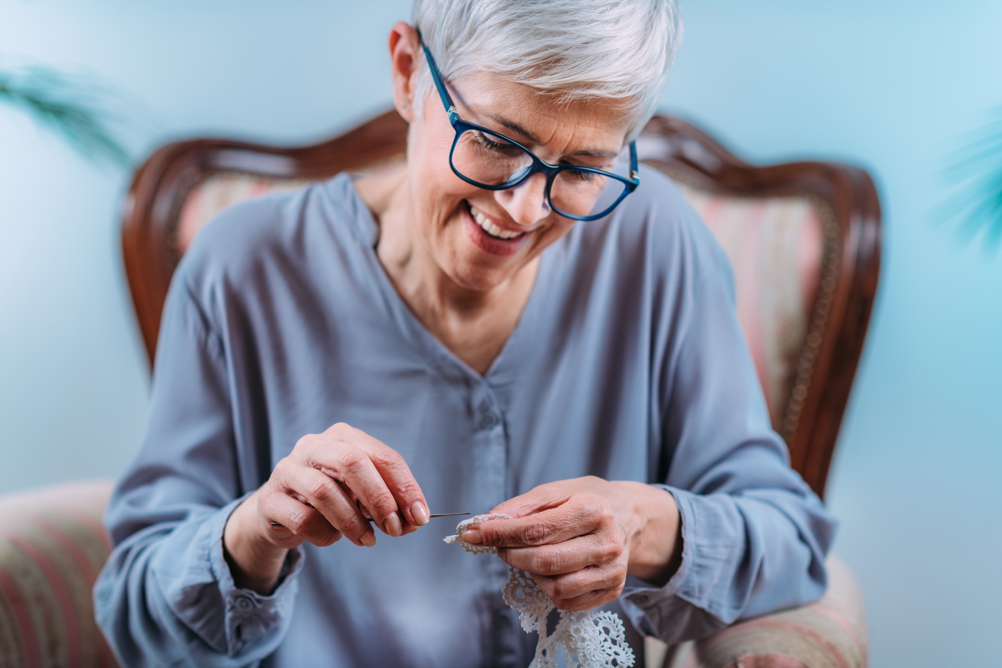 Senior Woman Doing Stimulating Brain Activity Crocheting at Home
