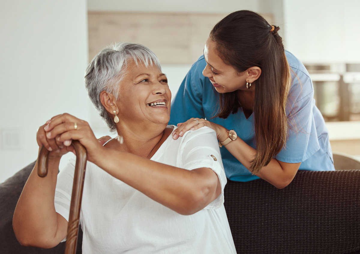 A nurse and elderly patient smiling at each other in El Paso.