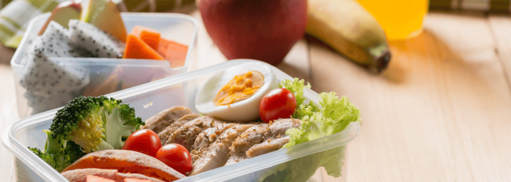 Healthy lunch boxes in plastic package, Grilled chicken breast with sweet potato, egg and vegetable salad.